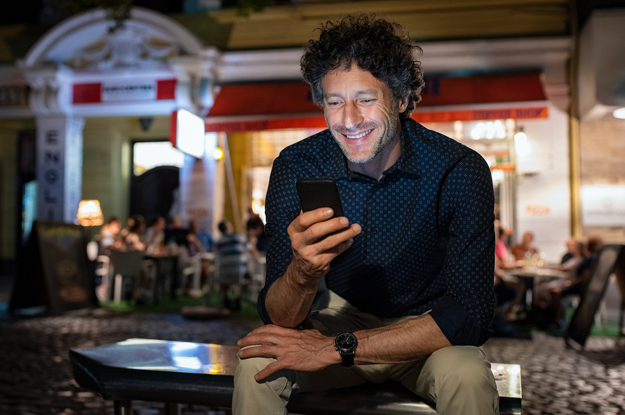bigstock-Smiling-mature-man-checking-ph-262820188