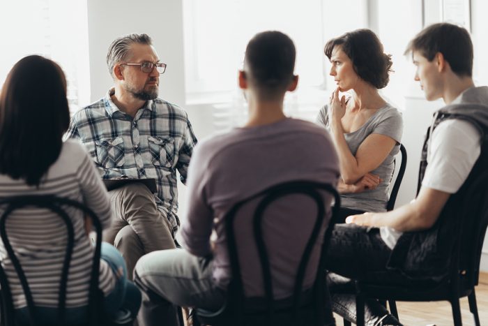 Woman Talking To Professional Psychotherapist In Support Group F