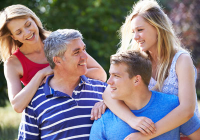 goodencenter-mental-health-treatment-photo-of-Happy-young-family-of-Family-With-Teenage-Children-Walking-In-Countryside