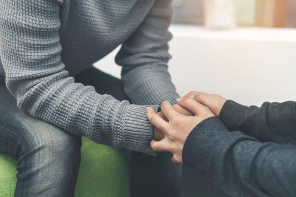 goodcenter-OCD-and-the-Drive-for-Success---Is-Residential-Treatment-the-Answer-photo-of-Psychologist-sitting-and-touch-hand-young-depressed-asian-man-for-encouragement