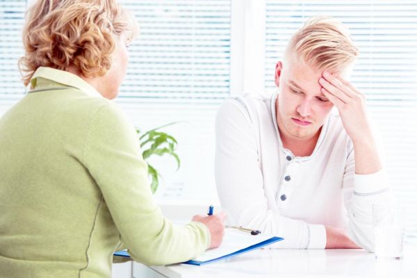 goodencenter-the-connection-between-mental-illness-and-substance-abuse-photo-of-a-doctor-talking-to-her-male-patient-at-office