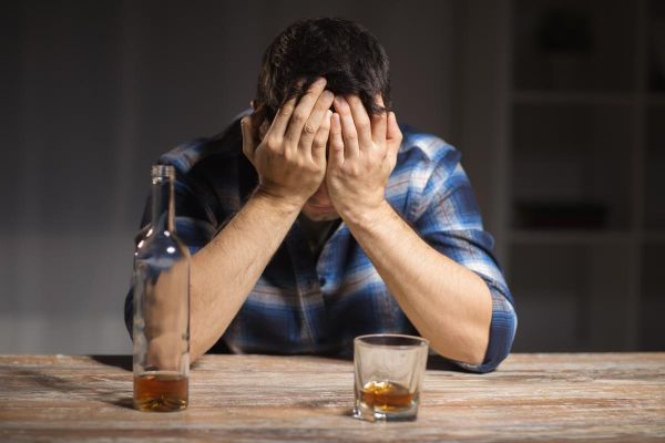 goodencenter-Why-Alcohol-and-Antidepressants-Should-Not-be-Mixed-photo-of-male-alcoholic-with-bottle-and-glass-drinking-whiskey-at-night