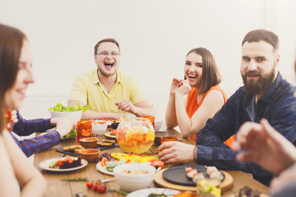 goodencenter-Nutrition-and-Mental-Health-photo-of-Young-people-having-fun-at-dinner-with-friends