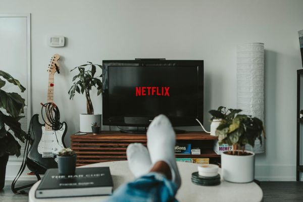 goodencenter-7-Tips-for-Enhancing-Your-Mental-Health-in-College-During-Covid-19--photo-of-young-man-watching-netflix