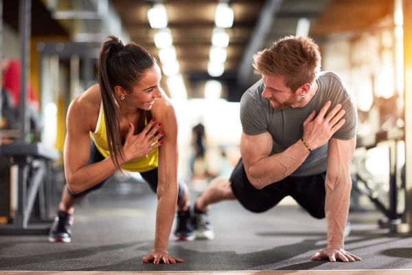 goodencenter-ten-Ways-to-Track-Your-Mental-Health-photo-of-Man-and-woman-strengthen-hands-at-fitness-training