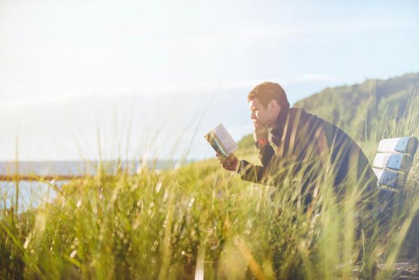 goodencenter-How-to-Help-Someone-Who-Is-in-Denial-of-Their-Mental-Illness-photo-of-young-man-reading-a-book