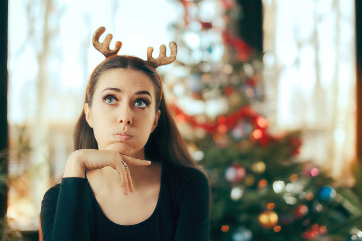 goodencenter-How-to-Maintain-Your-Mental-Health-over-the-Holidays-photo-of-a-sad-and-bored-beautiful-woman-on-christmas-day