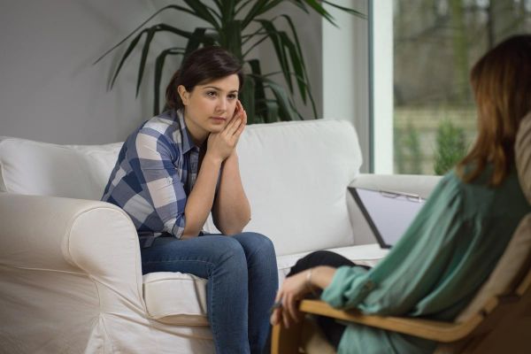goodencenter 5 Signs of Depression Relapse and How to Avoid Them photo of a young woman talking with a psychologist