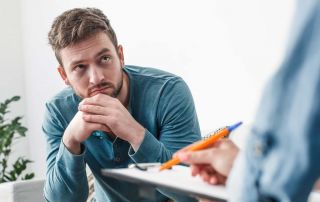 goodencenter PTSD and Addiction photo of a man with psychologist during theraphy drug addiction