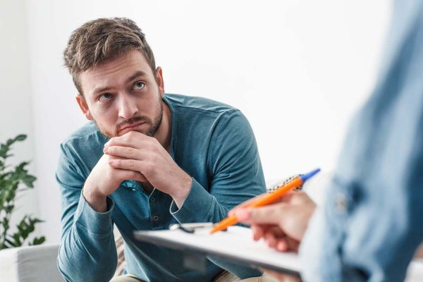 goodencenter PTSD and Addiction photo of a man with psychologist during theraphy drug addiction