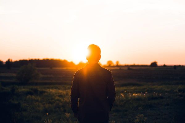 goodencenter-Using-the-Saint-Francis-Assisi-Prayer-in-Recovery-photo-of-man-standing-facing-sunset