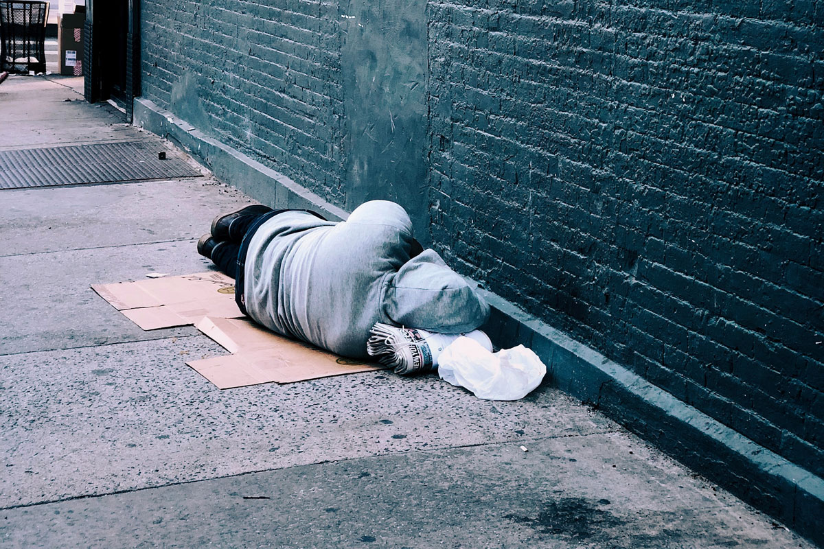 gooden center The Connection Between Homelessness and Addiction photo of a homeless man lying in the street