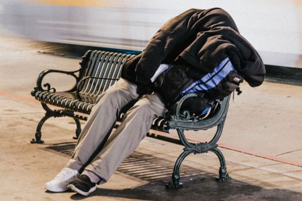 gooden center The Connection Between Homelessnessand Addiction photo of a homeless man sitting on a bench