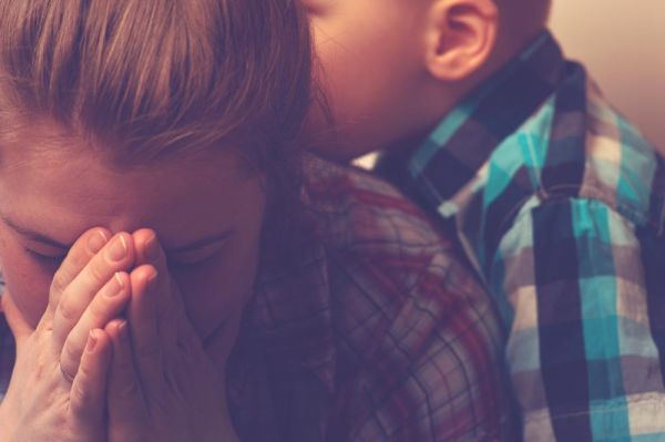 goodencenter How to Identify Signs of Mental Illness in a Loved One photo of a crying unhappy mother with child at home