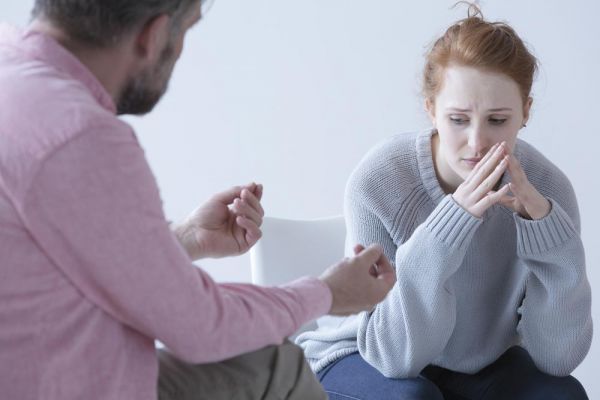 a psychologist discussing setting up boundaries to a woman who has a loved-one struggling with addiction