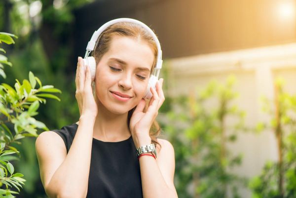 beautiful woman listening to music using it as a therapy for mental health