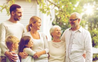 photo of a happy family standing in front of a rehab facility during for family therapy