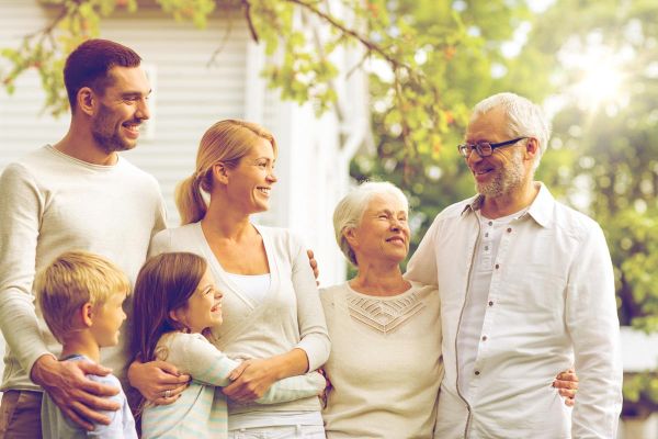 photo of a happy family standing in front of a rehab facility during for family therapy